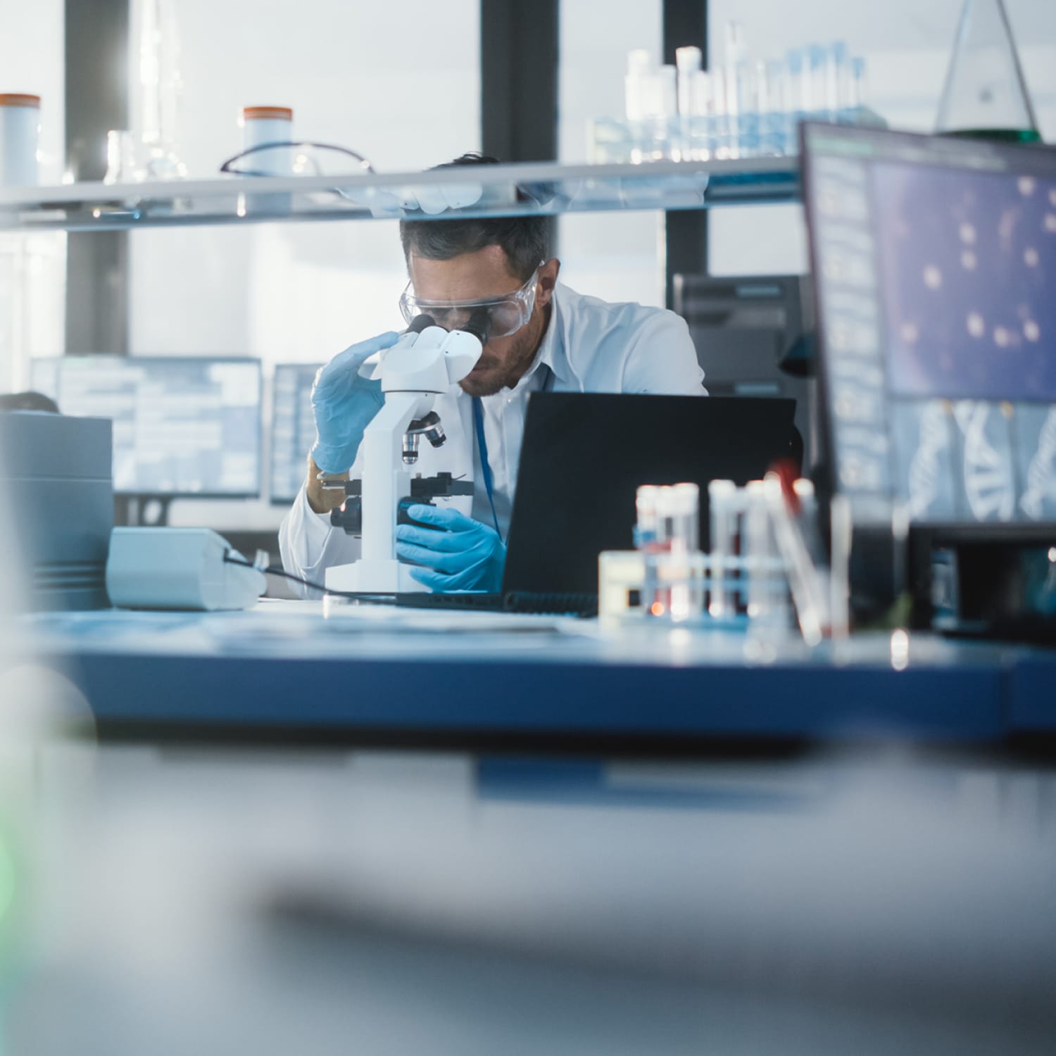 Researcher in the Lovelace research lab working with a microscope