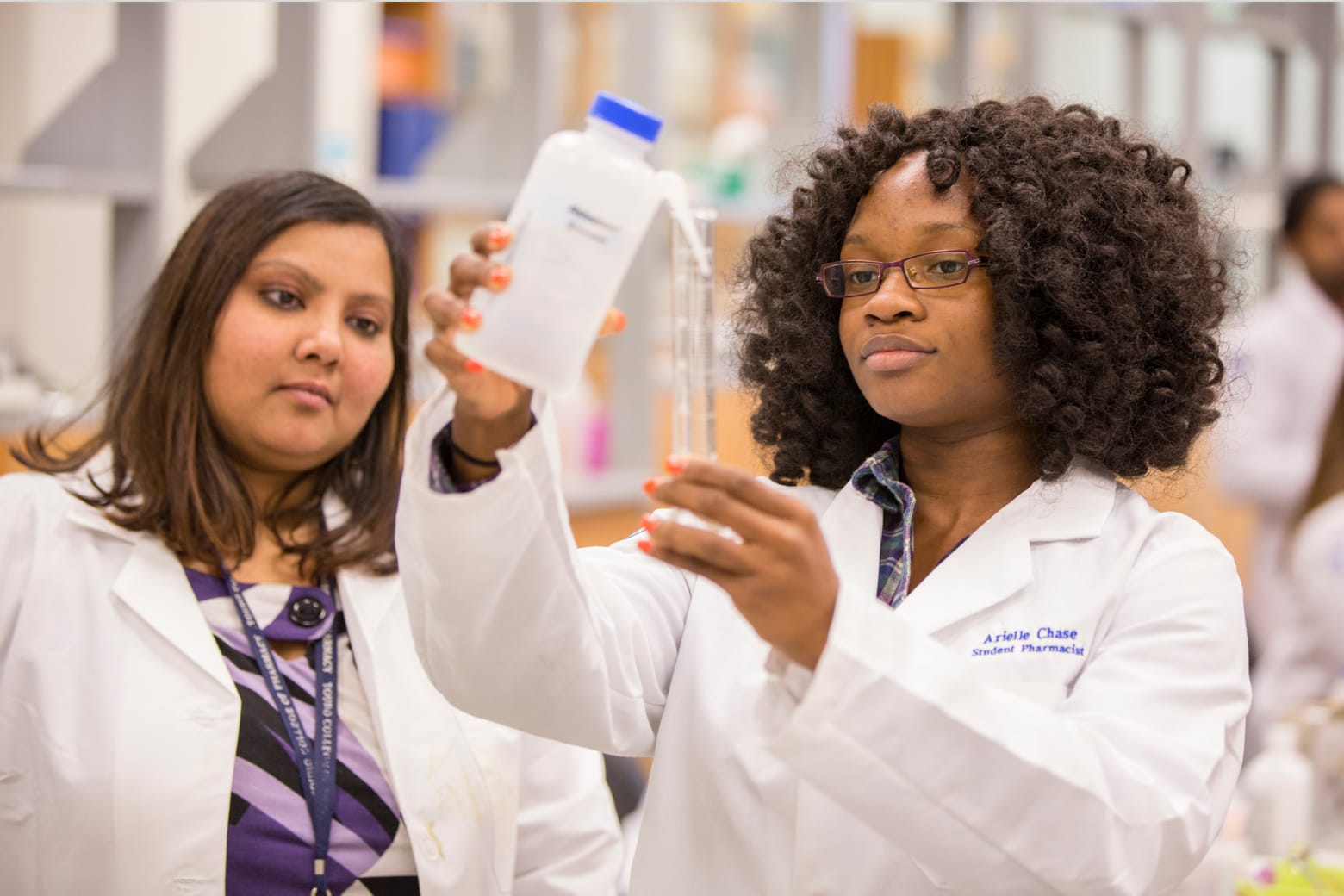 Two female TCUS researchers working in lab