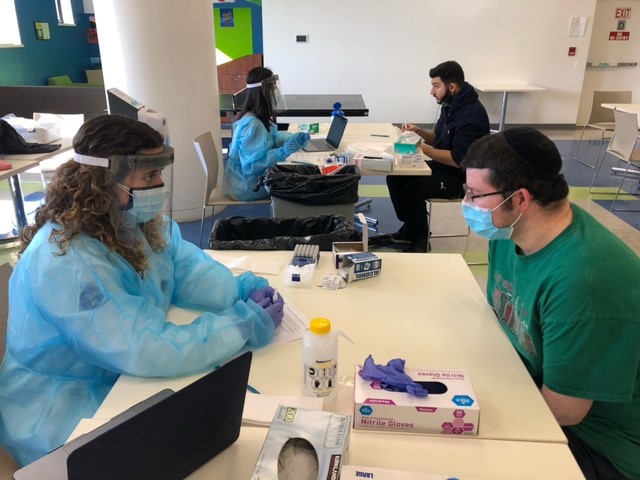 Touro College of Pharmacy professor, Dr. Rebecca Kavanagh, administering COVID-19 saliva tests to Touro College of Osteopathic Medicine student. 