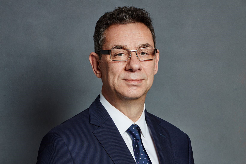 Headshot of Dr. Albert Bourla in suit and tie