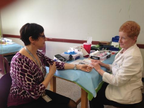 A Touro employee receives a biometric screening at the Spring Wellness Fair