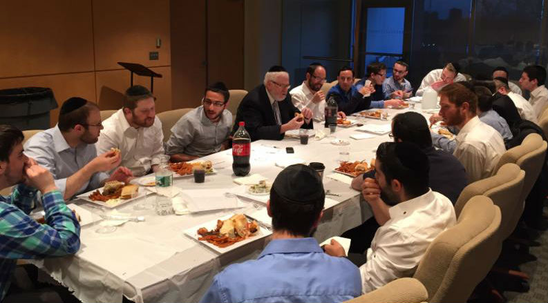 Menahel and Rosh Yeshiva Rabbi Yehuda Shmulewitz (far side of table, center) delivered a shiur on the importance of loving Israel as part of the first-ever Lander College for Men Back-to-Yeshiva Week for alumni.