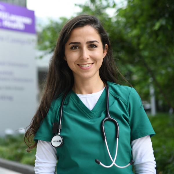 Emmanuella Rabaev, RN, BSN in scrubs outside hospital