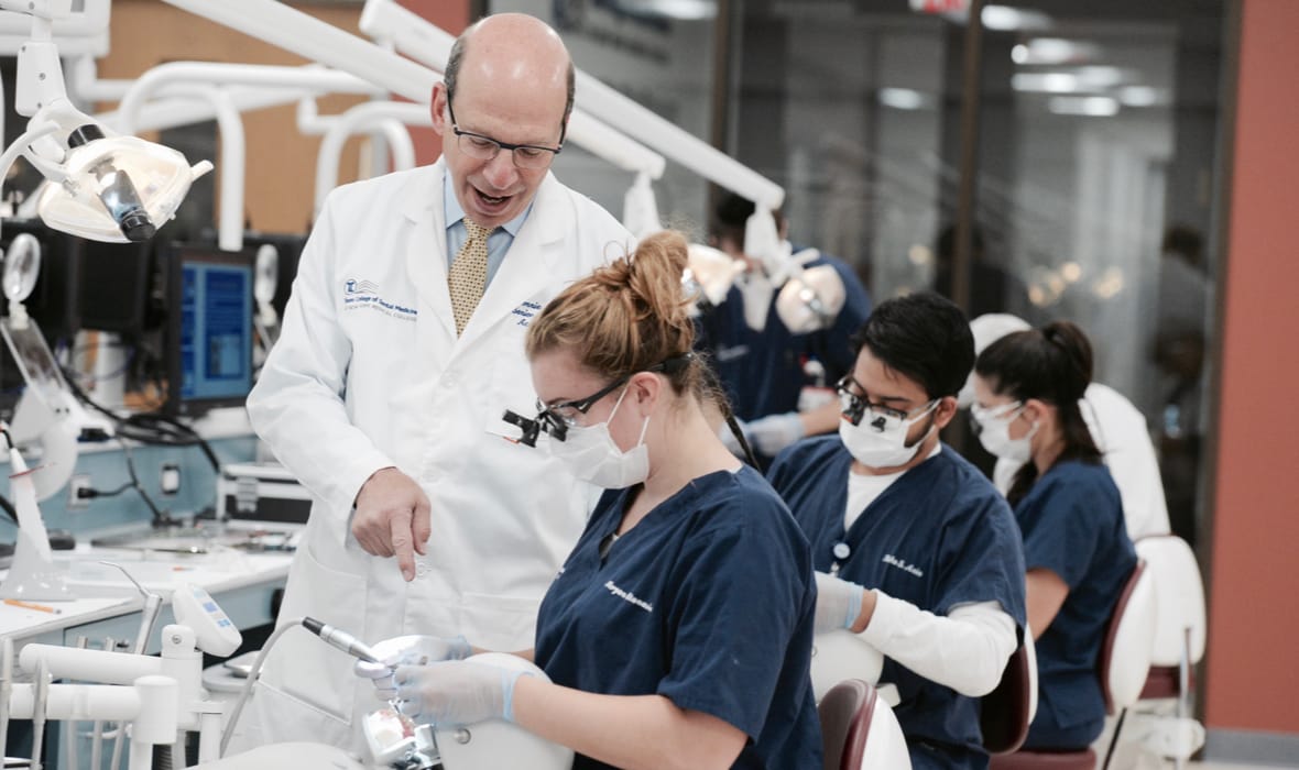 TCDM dean Dr. Ronnie Myers with Touro dental students in the sim lab